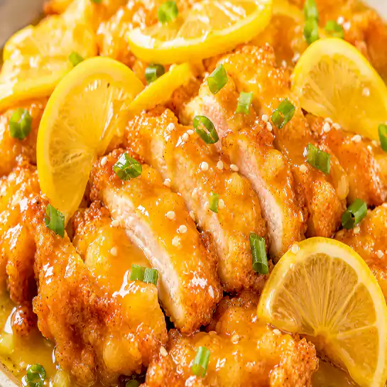 Crispy Golden Lemon chicken (Poulet au citron) glazed in a glossy zesty sauce at Harmonie Orientale, LaSalle, Montreal.