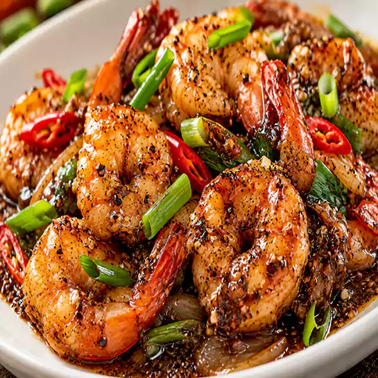 Savory Shrimps with black pepper (Crevettes avec poivre noir) featuring juicy prawns in a rich sauce at Harmonie Orientale, LaSalle, Montreal.